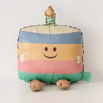Balon Folie Tort Aniversar Pastel 62x39 cm Balon din folie premium in forma de tort aniversar in dungi pastelate cu fata zambitoare si lumanare dimensiune 62 cm.
